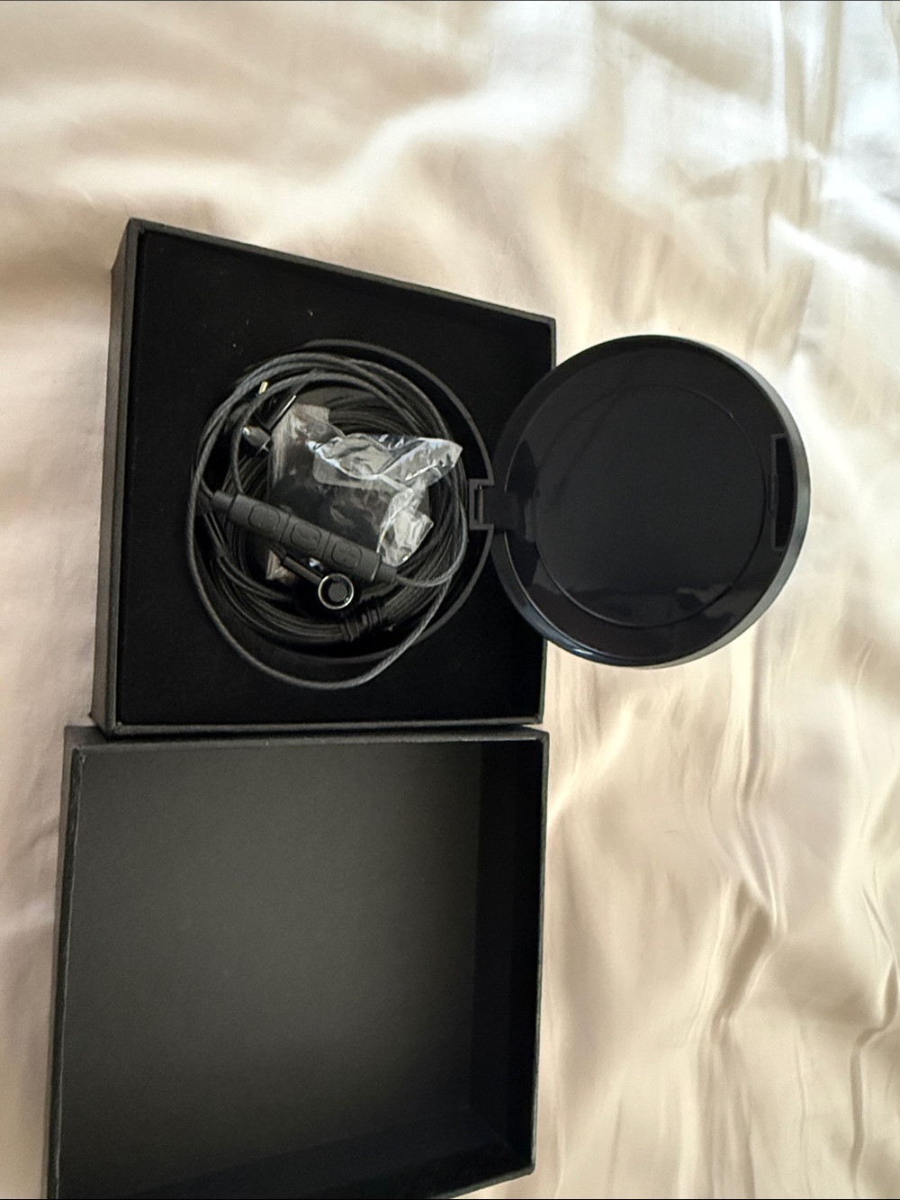 Black Wired Earbuds with Round Charging Case